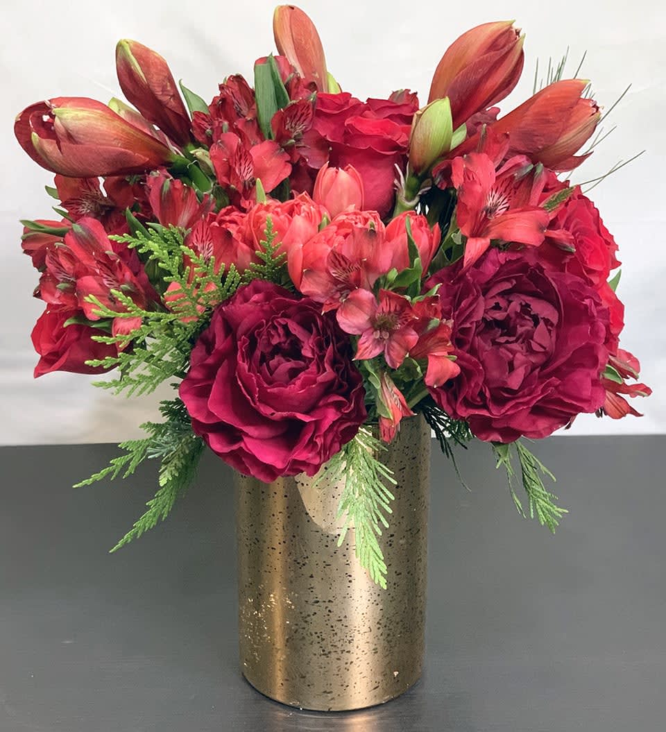 Holiday Magic - Deluxe ADH20-2 - The magic of the holidays in a gorgeous tone on tone floral arrangement of Peonies, Tulips, Roses, and other premium flowers and greens. Deluxe Version. This is the best of the best. Available in three sizes. Substitution of greens is available. Please note that in special instructions. Approximate size: 15&quot;x12&quot;