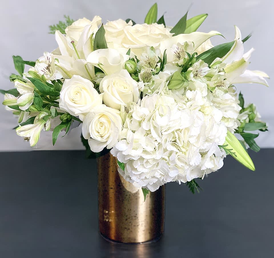 Celebration - Deluxe ADH20-5 - Help celebrate the holiday season with this incredible arrangement of Hydrangea, calla lilies, roses and other premium flowers. Deluxe Size with more flowers. Available in three sizes. Holiday greens can be substituted. Please request in special instructions. Approx Size: 15&quot; x 12&quot; 