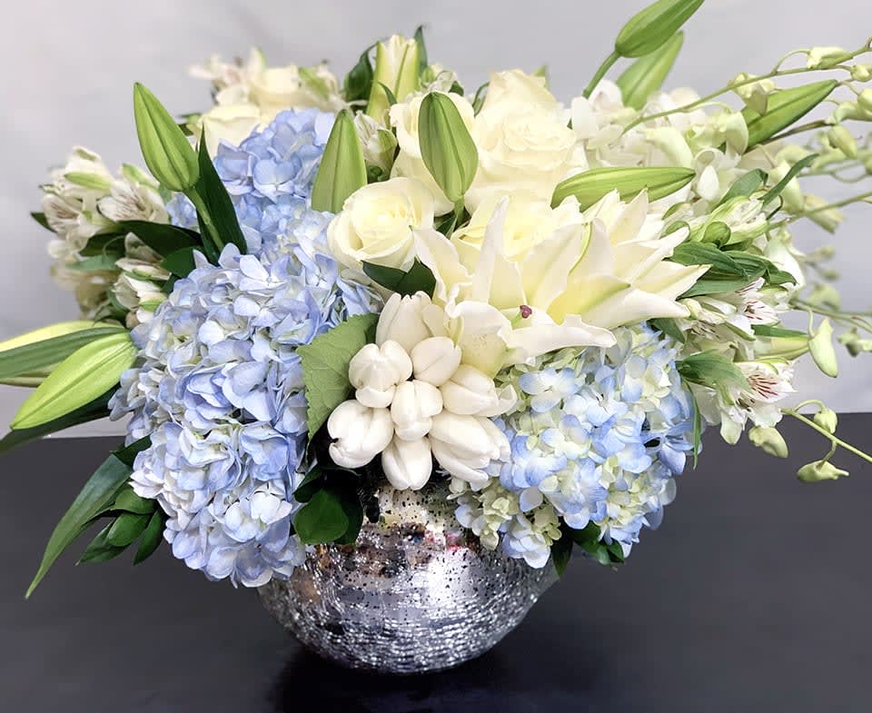 Holiday Lights - Premium ADH20-14 - The perfect holiday arrangement to light up a home or office. This gorgeous mix of blue hydrangea, roses, tulips and other premium flowers is available in two sizes. Premium version - Approx Size: 15&quot; x 18&quot;