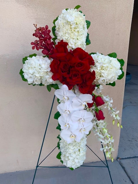 Forever Loved  - Sympathy cross designed in red and white flowers, with a dynamic diagonal design of red florals. 