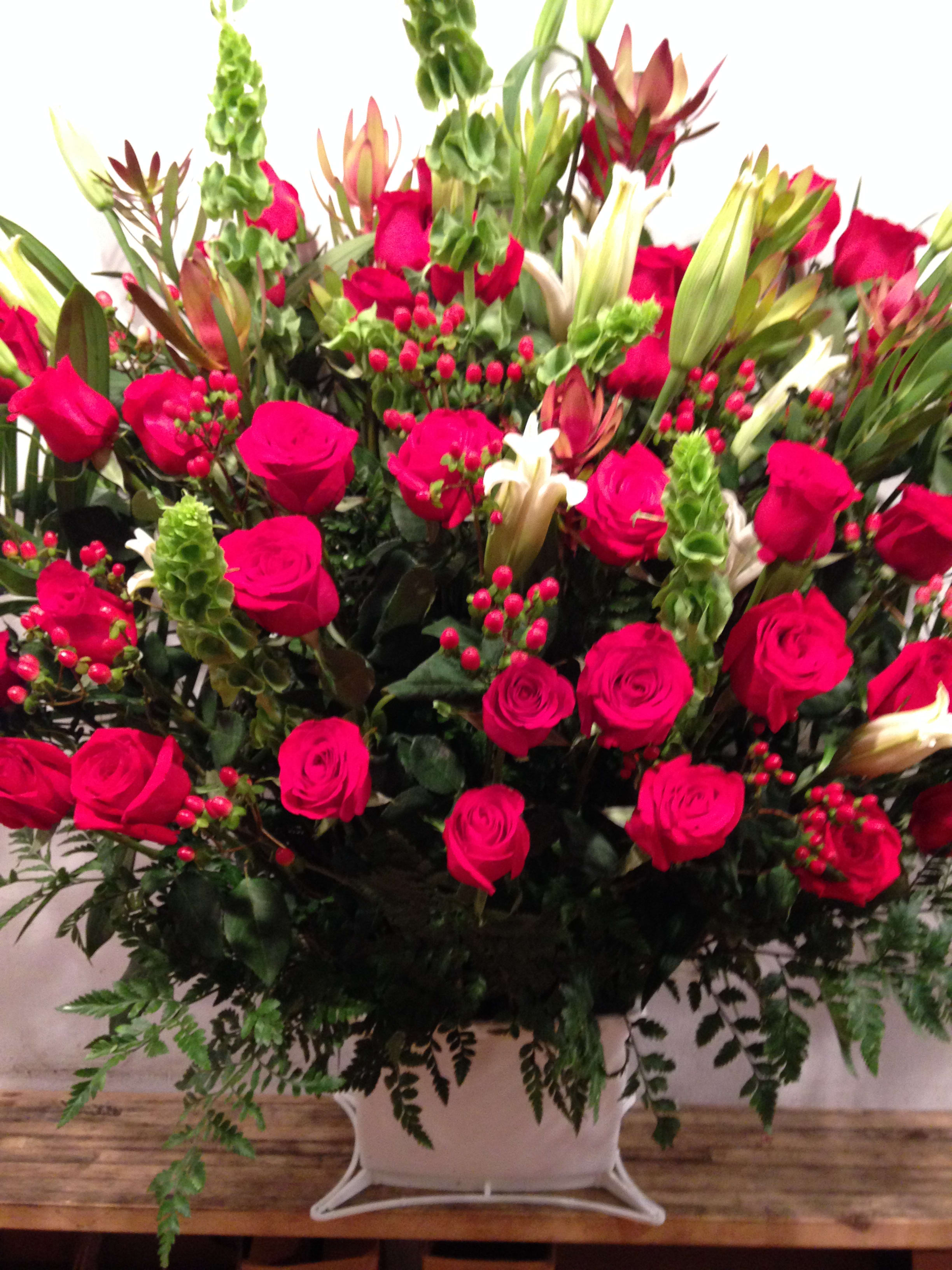 Red Sympathy Basket (Pre-order) Red Sympathy Basket (Pre-order) - This large event piece is presented in a white basket and is complete with red roses, red hypericum, casa blanca lilies, Bells of Ireland, safari branches, palm leaves and miscellaneous greenery. (Some flowers may be subject to change depending on the season. We will contact you with available flower substitutions; please contact us with specific questions if you are concerned with flower availability, thanks!) Featured arrangement: $500 (Regular Price)