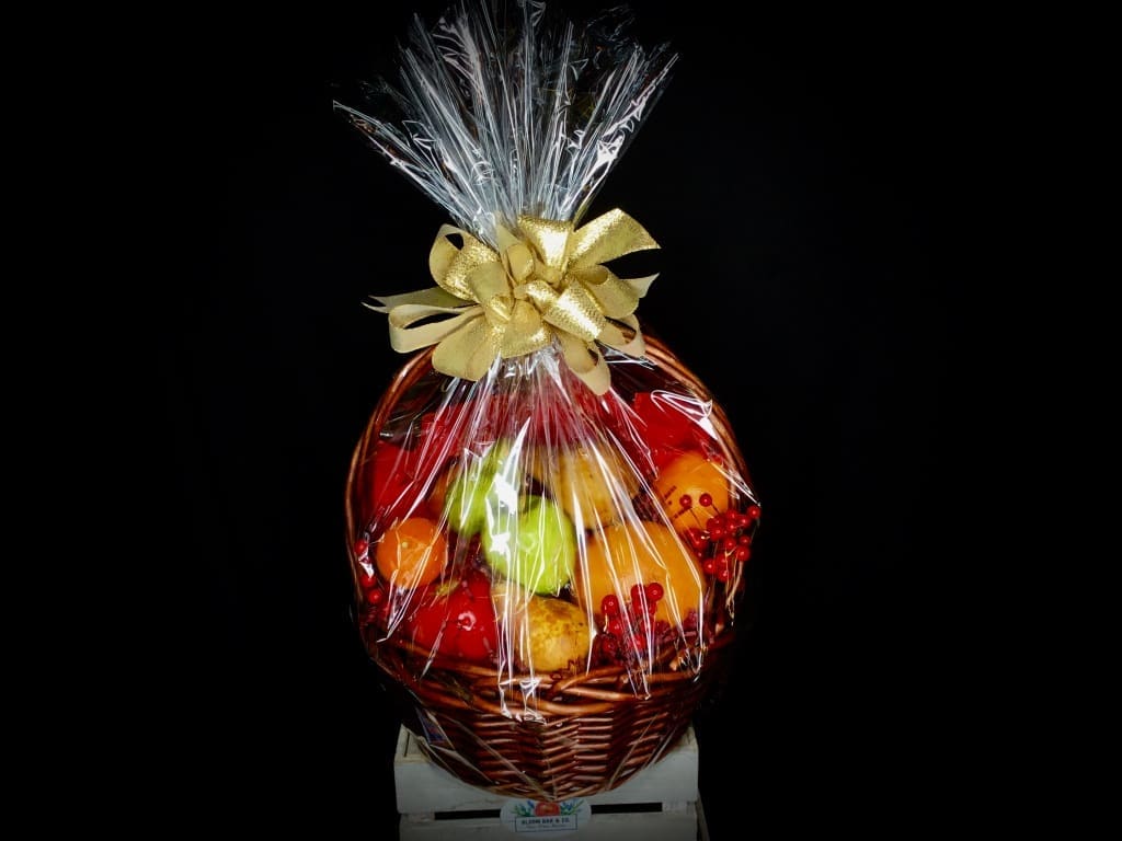 Seasonal Fruit Basket Seasonal Fruit Basket - A sturdy basket brimming with fresh, juicy fruit, ready to display beatifully on a kitchen table or counter! Cellophane wrapped with seasonal decorations and a bow in colors of your choice.
