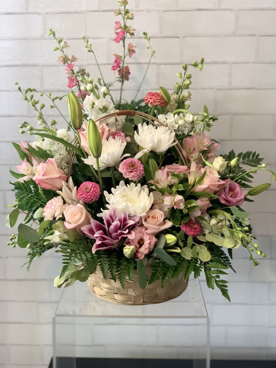 Harmony  - This pink and white funeral basket is a lovely sendoff and tribute. Fitting for any type of ceremony. 