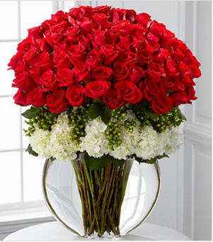 Lavish Luxury Rose Bouquet - Lavish your special someone with a bouquet that will leave them breathless. Silky red 24-inch premium long-stemmed roses offer a message of passionate love and affection arranged amongst a bed of white hydrangea blooms elegantly accented with clusters of green hypericum berries. Arriving in a superior clear glass pillow vase, this luxurious bouquet will leave a lasting impression. Stands approximately 33-inches in height. Your purchase includes a complimentary personalized gift message.
