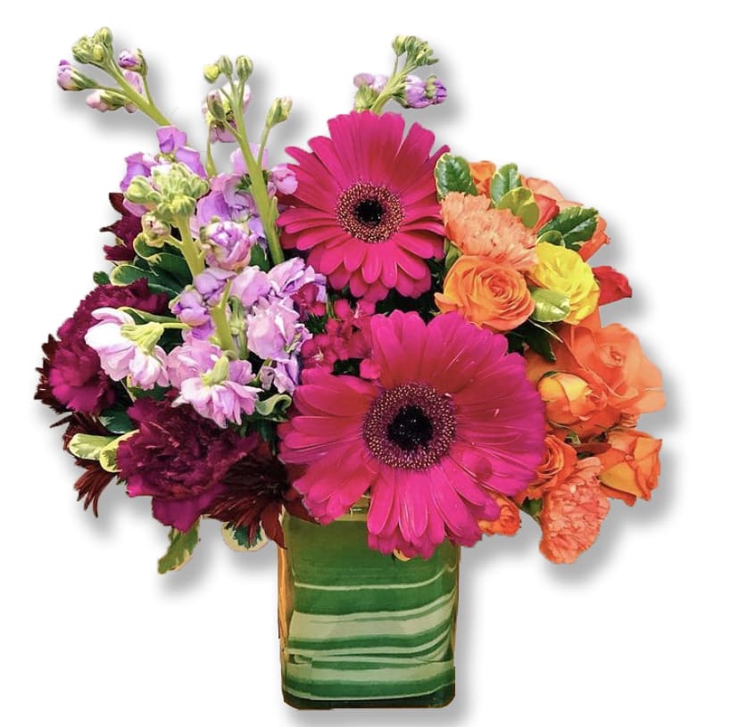 FTD The Runway Ready Passion For Fashion Bouquet  -  Starting with soft peach roses, its colors flow seamlessly to orange spray roses and carnations, then hot pink gerbera daisies and into purple button poms and plum carnations. This chic bouquet comes hand-arranged, ready for display in its accompanying vase, a simply elegant glass rectangle with tropical Ti leaf lining. Designed to appeal to the most discerning and sophisticated tastes, it makes a stunning birthday, anniversary, or thank you gift. Deluxe shown in the picture.