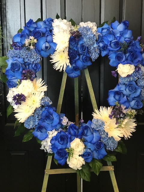 Masculine Heart on Easel Masculine Heart on Easel - Classic heart on a easel in photo made in blue and white but can be created from any 2 shades . in photo created with white spider mums ,blue carnations,blue dalphinium, blue roses and trimmed with lemon leaf