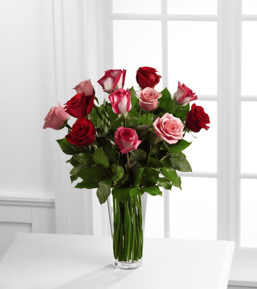 The FTD® True Romance™ Rose Bouquet - The FTD® True Romance™ Rose Bouquet is the perfect expression of love and passion to make this a truly memorable Valentine's Day. A bright burst of color, this bouquet combines red, pink and fuchsia roses, accented with beautiful greens and seated in a clear glass vase, to create a truly romantic representation of your love.  