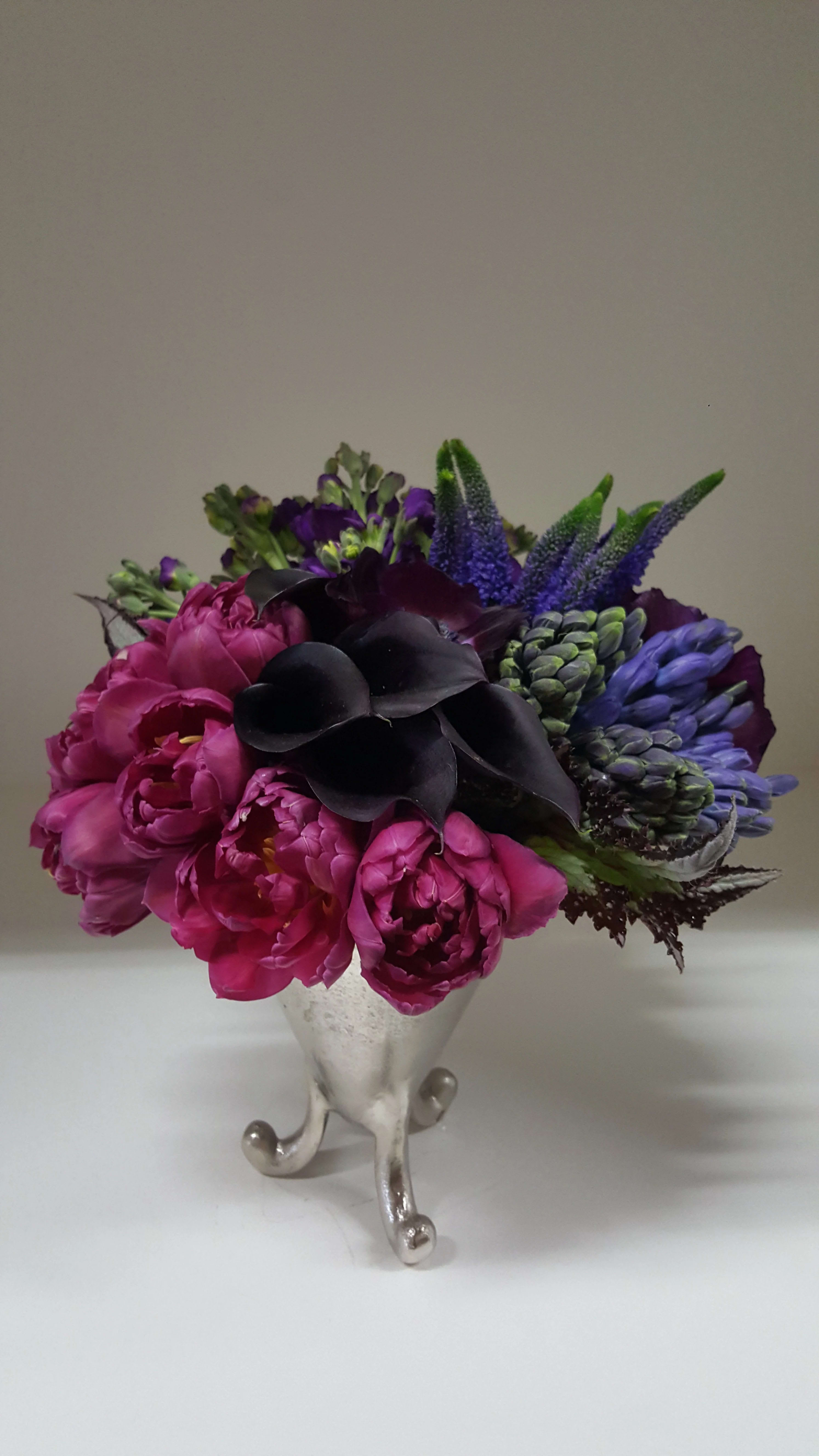 Jewel Cabachon - A jewel tone mix of premium florals and placed in a modern metal vessel.