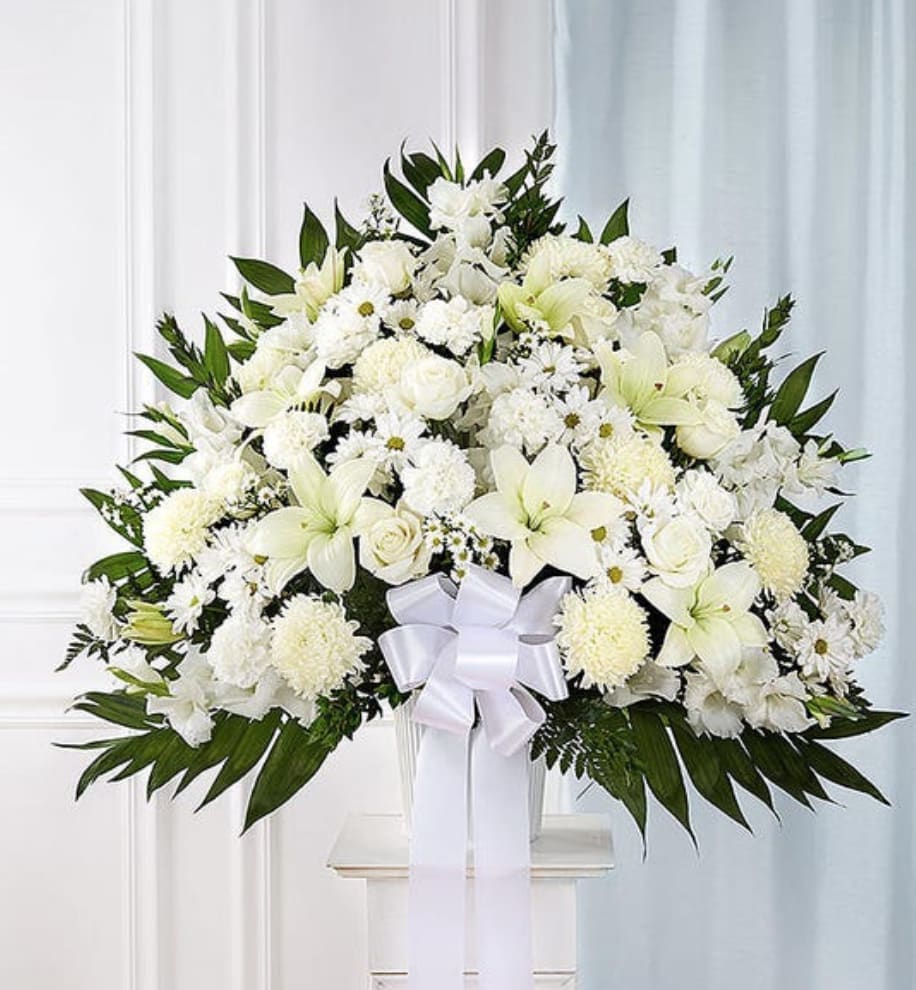 Sympathy Basket: All White - Symbolizing peace, serenity and purity, white flowers can help comfort those grieving the loss of someone they loved dearly. Our majestic standing basket arrangement in angelic white is an impressive tribute to their memory. Artistically designed with an abundance of pristine white blooms, it is a heartfelt expression of your deepest sympathies.