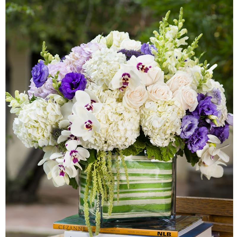 Love Hydrangea  - White Hydrangea with purple lisianthus and phalaenopsis orchid  tucked in square vase.