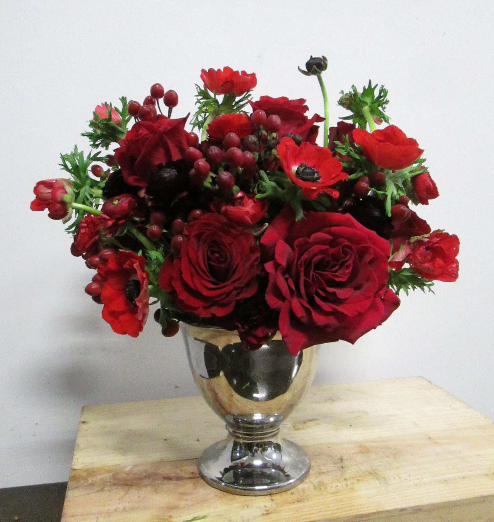 Classic Love Classic Love - Lush traditional with red garden roses, anemones and ranunculas; whimsical and playful. Overall size 14-16"