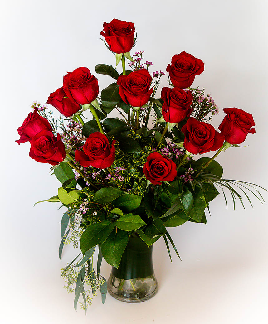 A Dozen Red Roses - For the perfect, traditional Valentine’s Day bouquet – or for a birthday, anniversary or other special day – this bouquet of a dozen red roses adorned with lovely waxflower, greens and ferns is a classic gift of love. Send it today, and she’ll love you forever. Available in many colors.