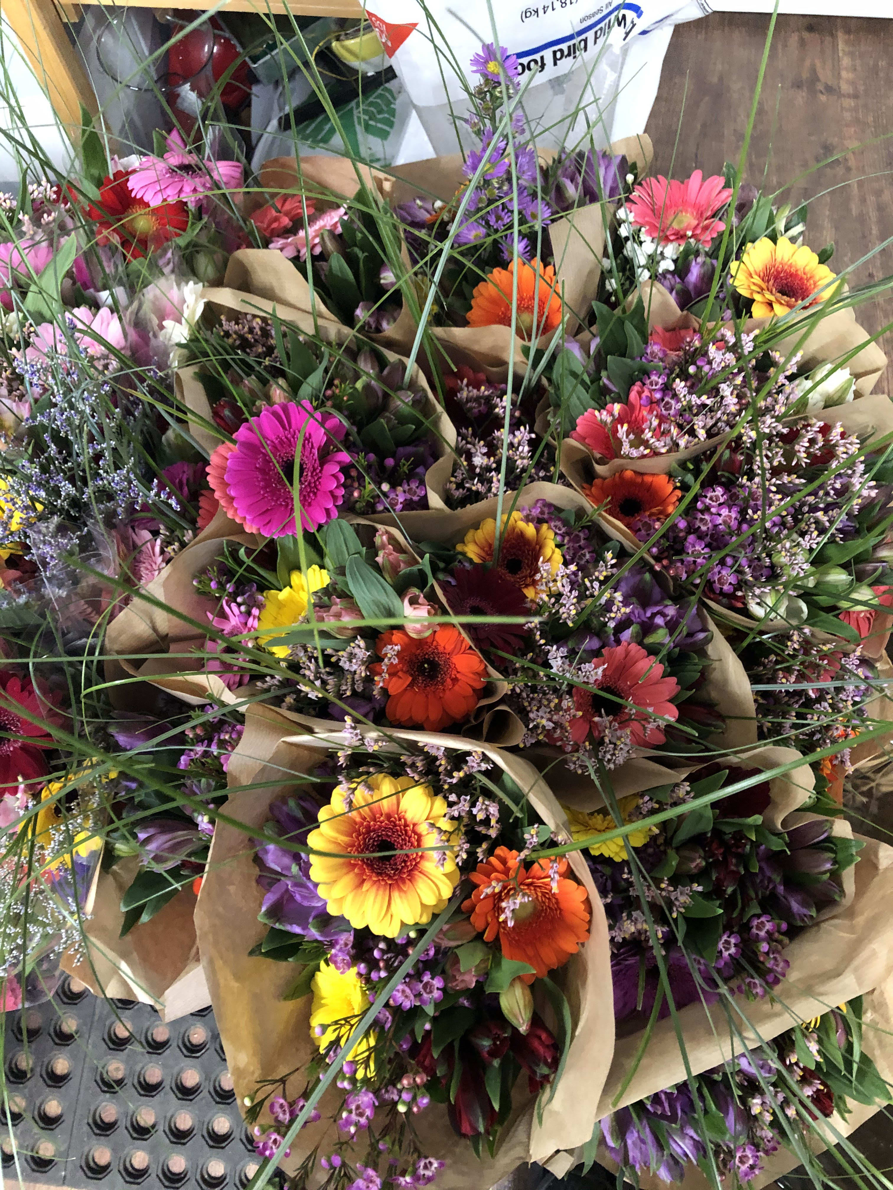 Wrapped bouquet - A nice mix of seasonal flowers wrapped presentation style on water tubes.  This is perfect for the person who has a vase, but needs the flowers to fill it. We can customize in the colors that  you are looking for as well. 