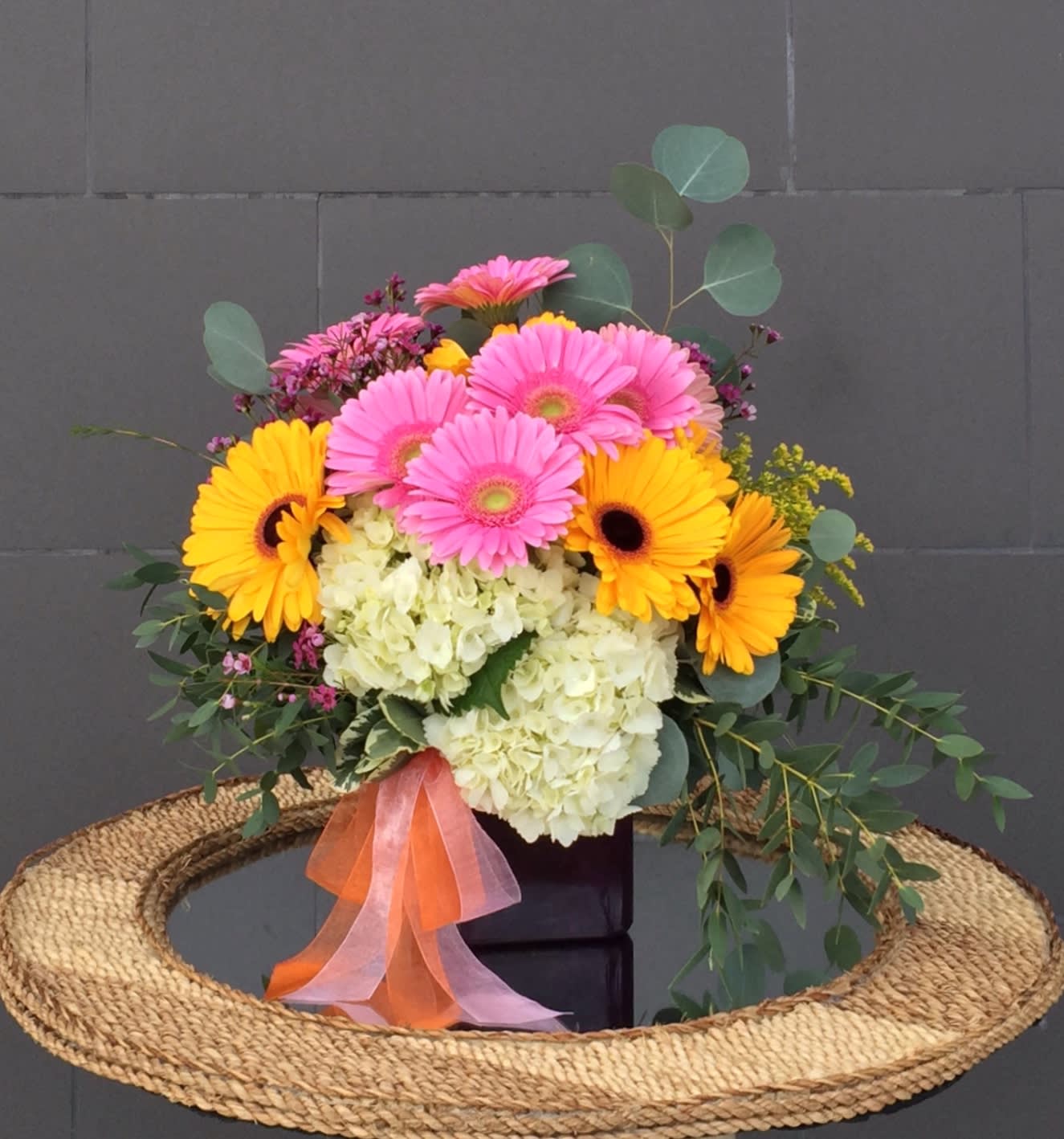 Fun Melody - Pretty design including gerberas, hydrangeas and accents in a glass vase.
