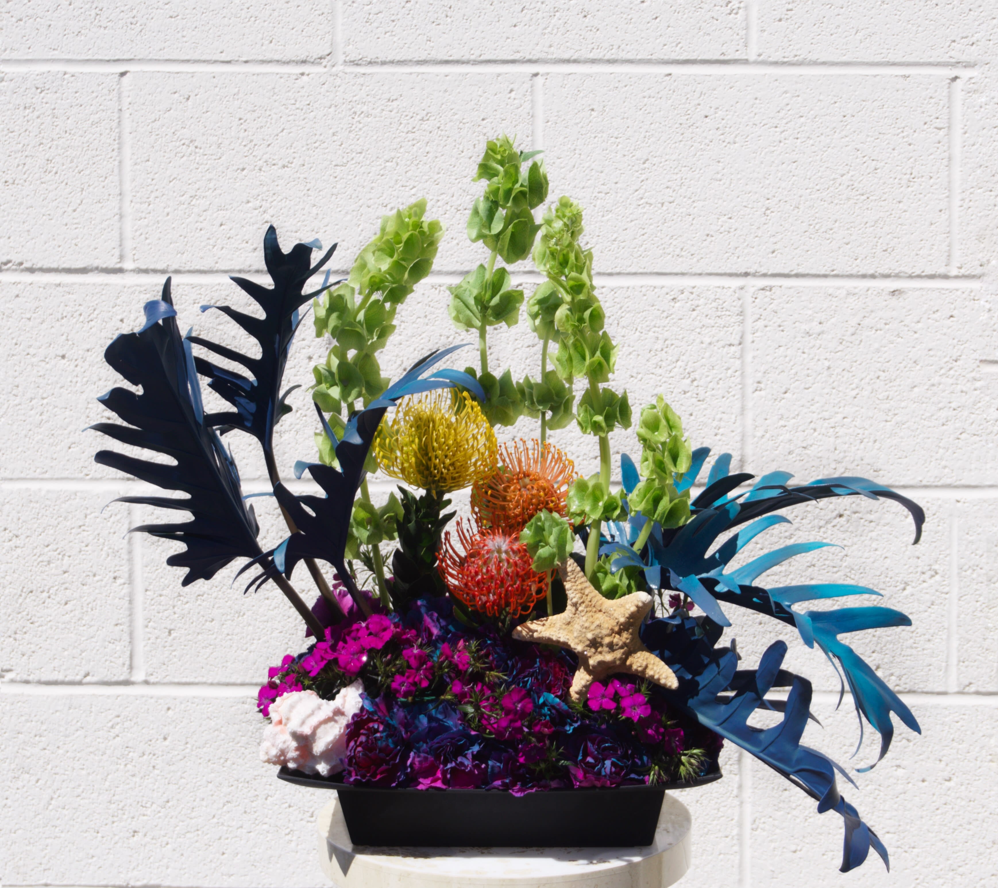 Coral Reef - Like colorful Coral Reef, this design includes pin cushion, bell of Ireland, sweet william... and oceanic accents.  STANDARD: FIRST PHOTO DELUXE: SECOND PHOTO