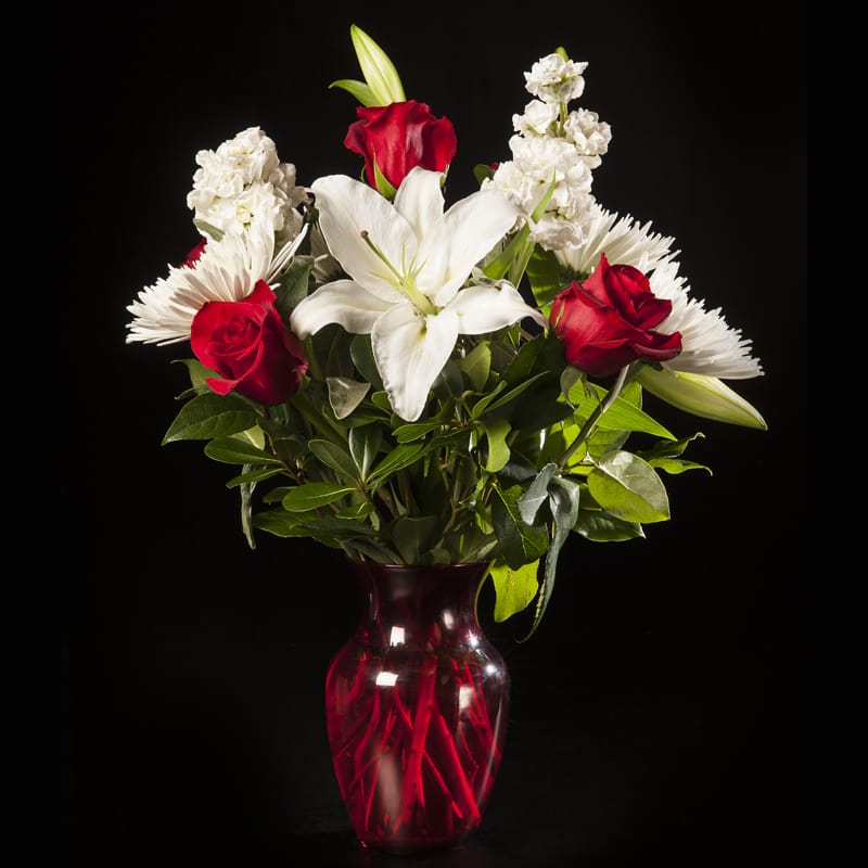 XoXo - Send your love or ramp up the romance with this adoring bouquet of red and white.  Classic red roses and white lilies make the perfect statement.