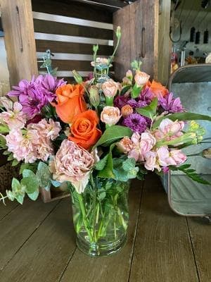 Spring Medley  - A nice medley of peach, purple and orange nestled in to this vase. 