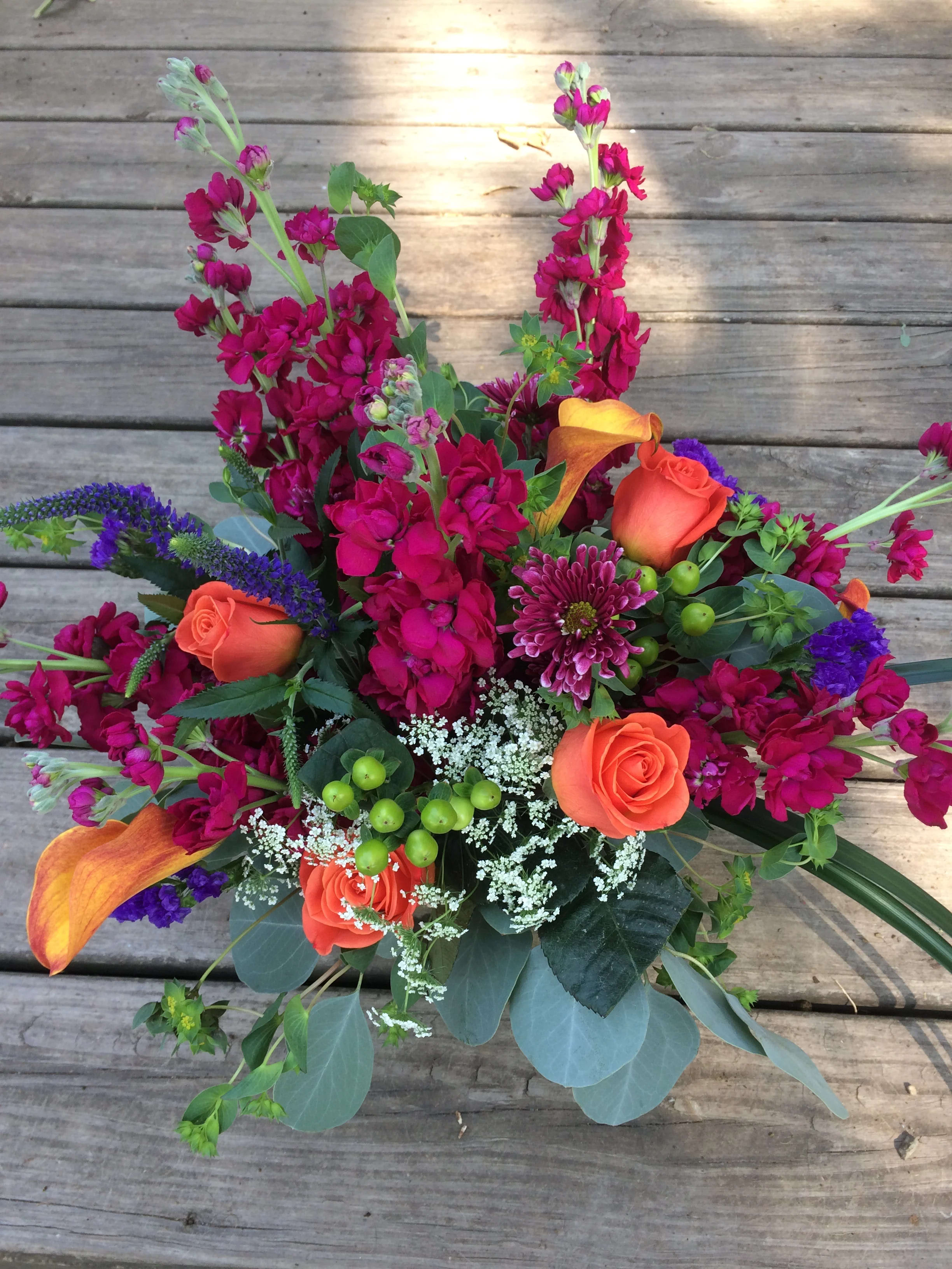 Breezy Blooms - A bright colorful bouquet in a square cube vase with purple stock, mango mini calla lilies, and orange roses are the highlight of this bouquet. This late summer/fall bouquet is a top seller for birthdays, anniversaries or just because. Picasso Floral Design Studio will hand deliver.