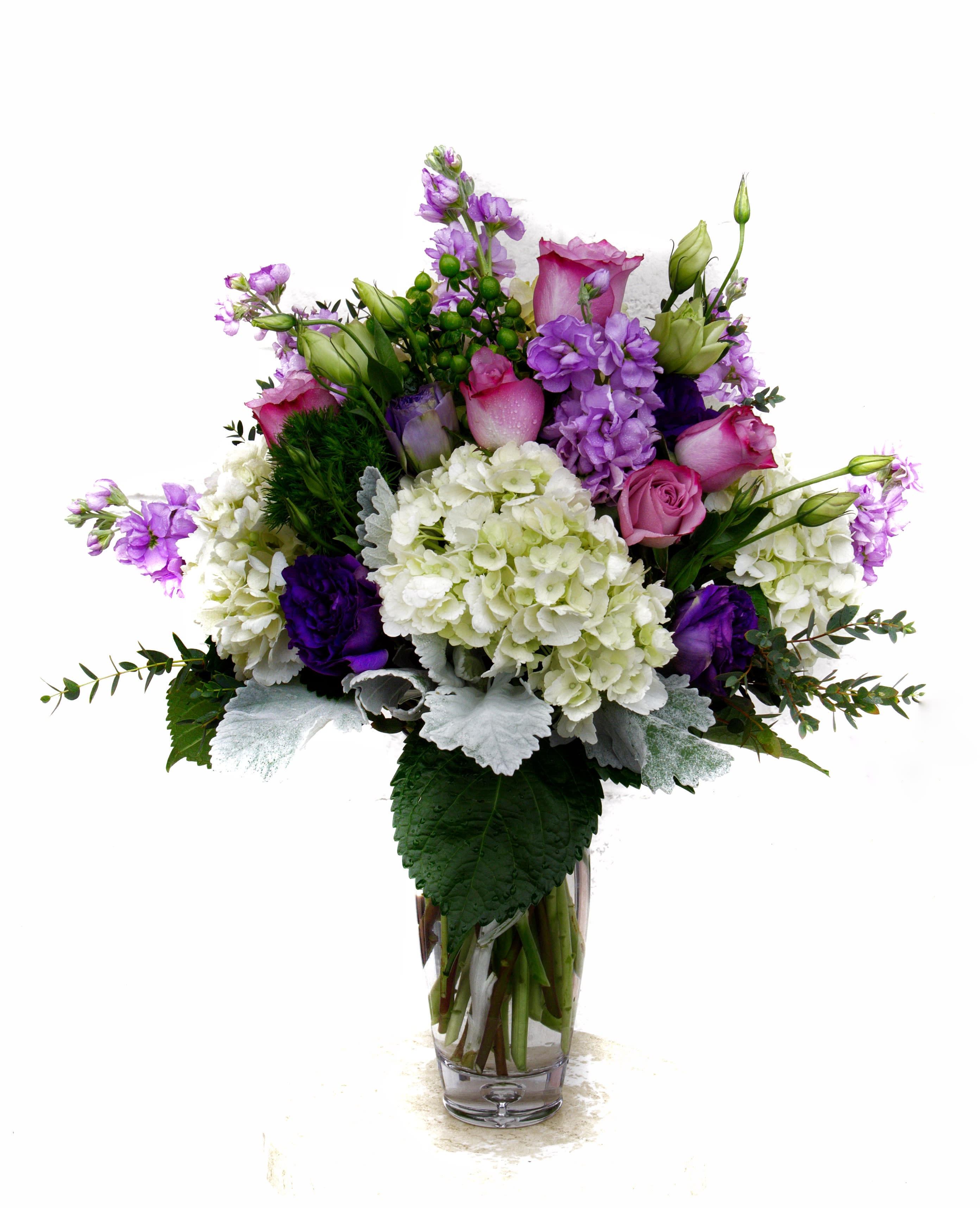 Pretty Violet - Lovely purple flowers including rose, soft lisianthus, fragrant stock, hydrangea and accents in a tall glass vase.