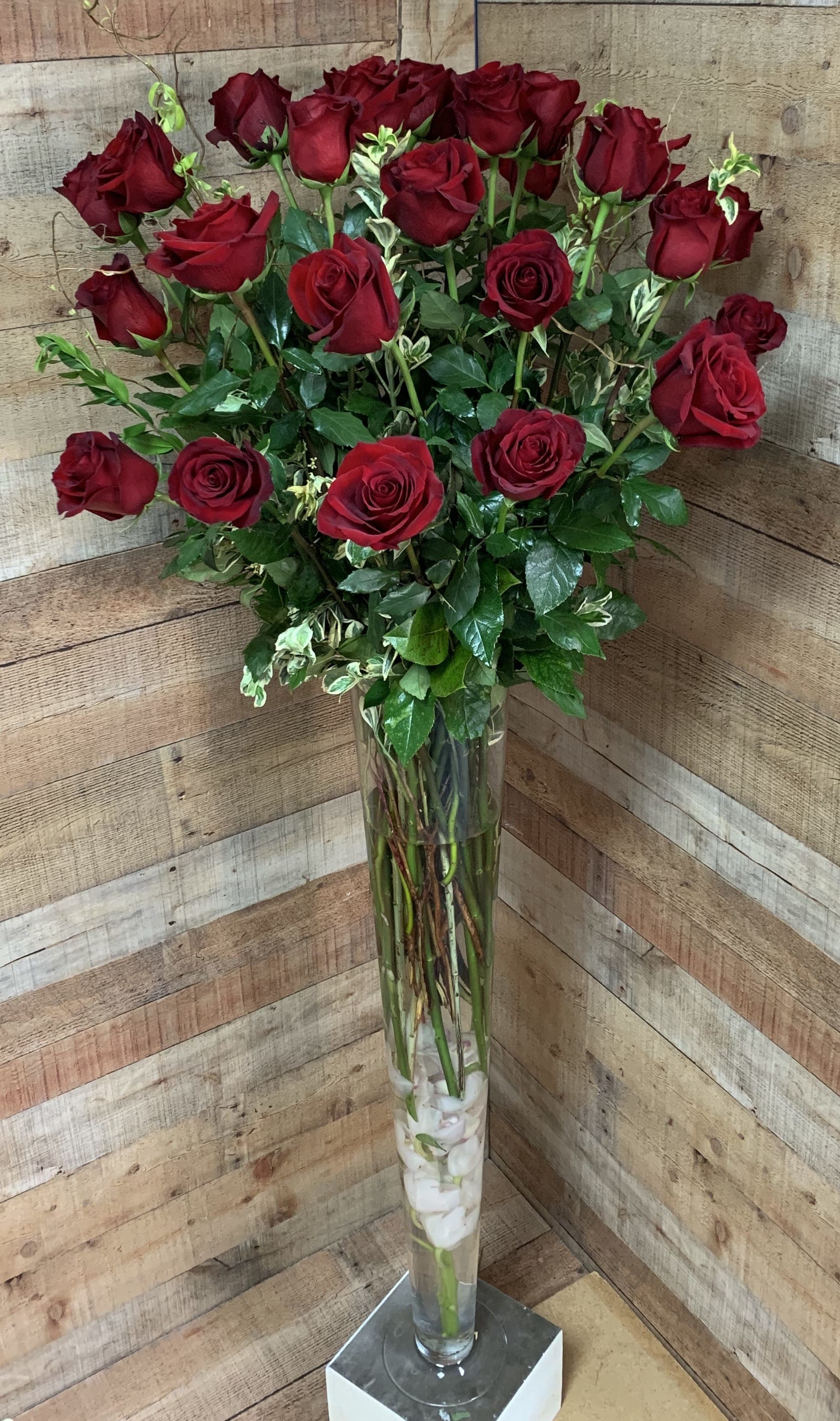 Forever Yours - 2 Dozen 4 ft roses in a glass vase.  Once in vase height is between 5'-5.5' ft.   Must order a minimum of 1 week in advance for availability. 
