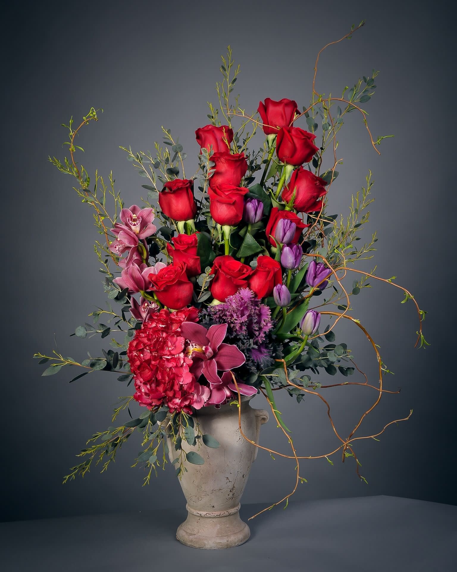 Love is in the Air Love is in the Air - Composed of roses, tulips, hydrangea, orchids, curly willow, variety of greens.