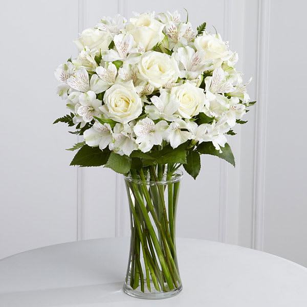 The FTD Cherished Friend Bouquet - The FTD&reg; Cherished Friend&trade; Bouquet offers comfort and sympathy in the time of grief and loss. Bright white roses and Peruvian lilies are accented by lush greens and gorgeously arranged in a clear glass gathering vase to create a bouquet that will bring peace and show how much you care.