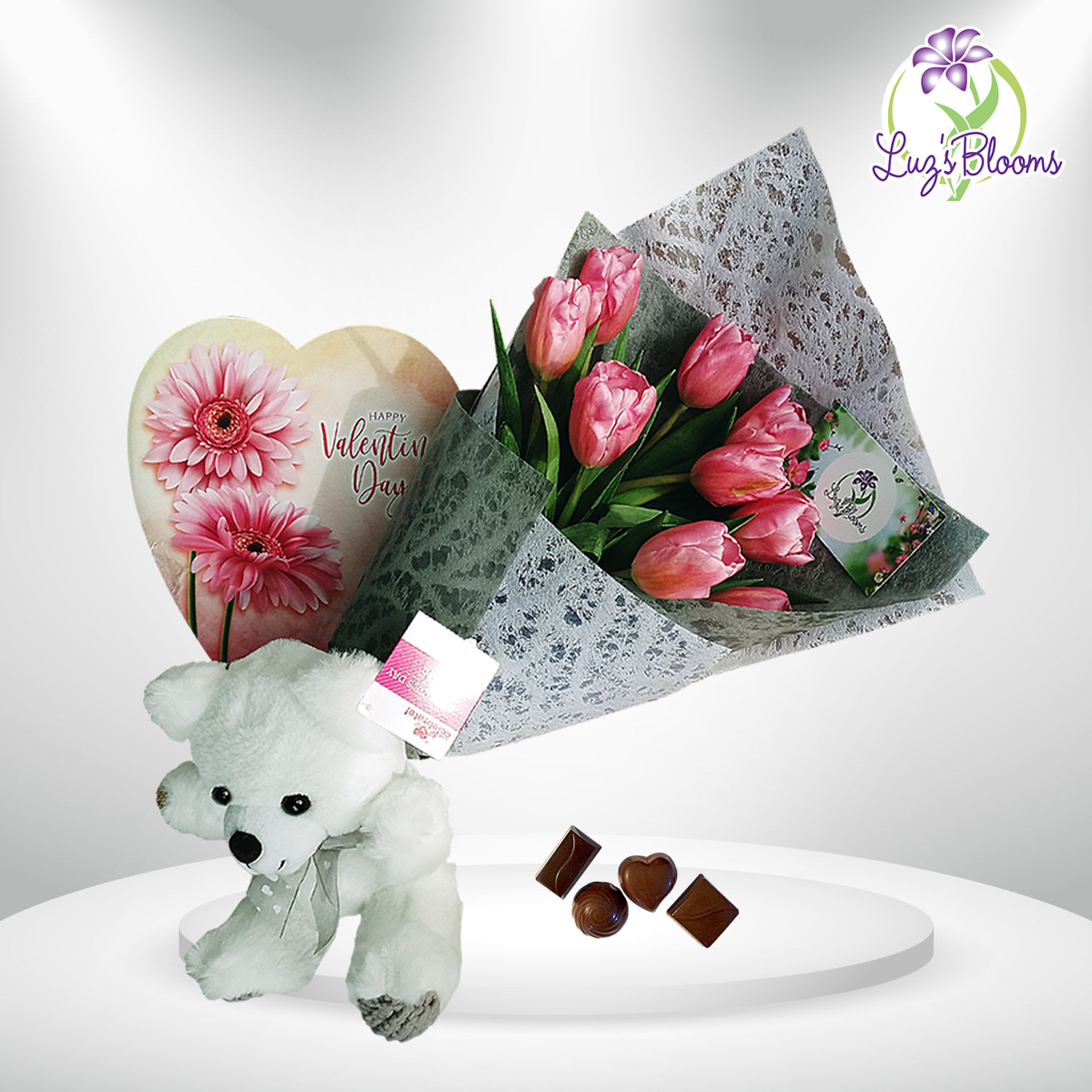 Full Vday - A hand of bouquet with tulips, a Teddy bear, and a heart of chocolate.