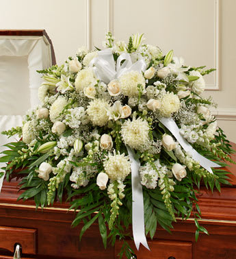Cherished Memories White Half Casket Cover - Reverence. Honor. Remembrance. Peace. All of these thoughts are expressed beautifully with this elegant tribute. Crafted by our expert florists from pure white blooms to symbolize the joyful, loving person who has passed, and the life they shared with everyone around them, it makes a beautiful final tribute to a beloved family member. 