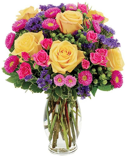 BF17211 - JUST BECAUSE Yellow and hot pink roses, hot pink Matsumoto aster, purple statice and green hypericum cascade wonderfully in this breathtakingly striking arrangement that sits so elegantly in a clear fluted vase. 