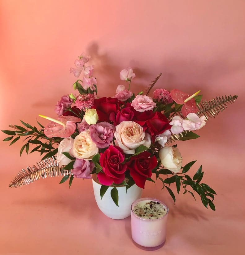 Miss Daisy Valentine's Day Gift Set - Florals + Candle Miss Daisy Valentine's Day Gift Set - Florals + Candle - Try our popular rose scented house branded candle paired a classic floral arrangement for any occasion! Delivery options are available or you can stop by and smell this wonderfully fragrant candle that has dried rose petals and crystals glistening on top.