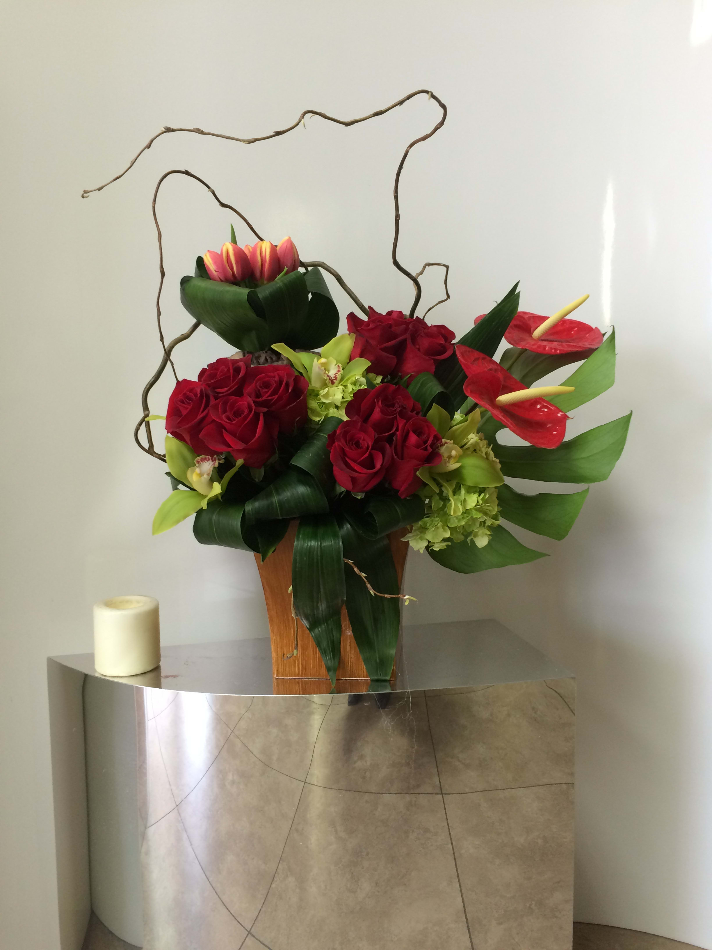 Enchanted Red Roses Enchanted Red Roses - Red Roses, cymbidiums and more in a beautifully arranged square box vase.