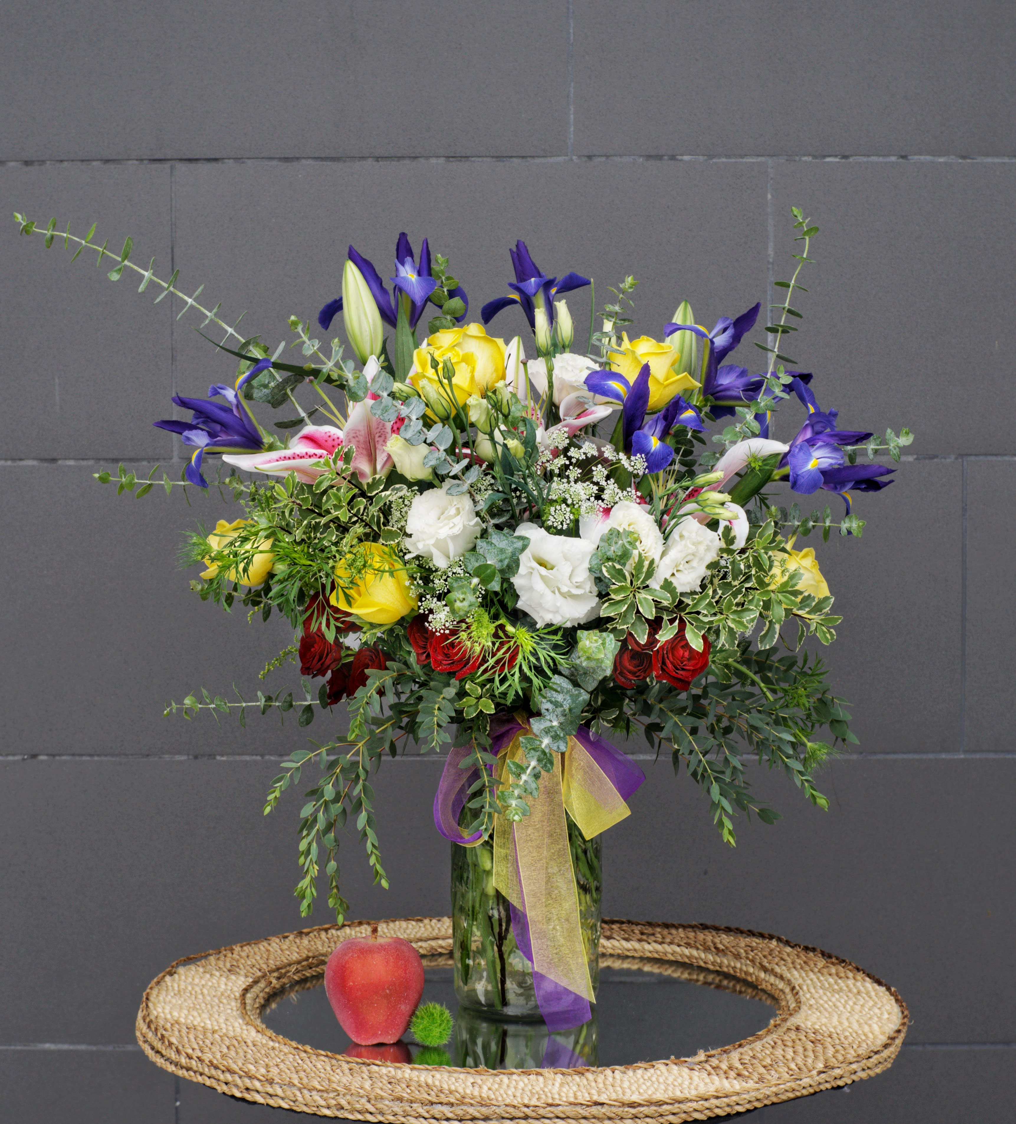 Congratulations - Colorful design including rose, lily, iris... and nice accents in a tall glass vase.