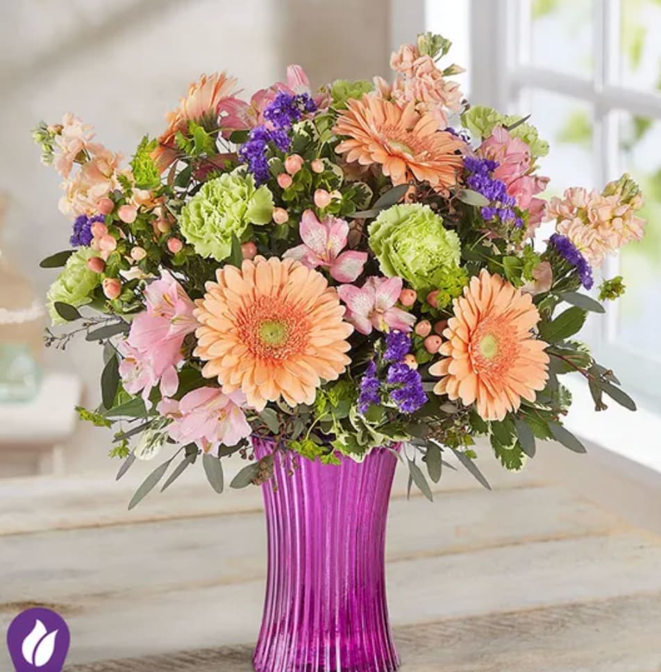 Garden Inspiration™ Bouquet - Some gifts were made to delight. Our garden-inspired bouquet features a loose gathering of blooms in peach and pink, with hints of rich purple, creating the perfect complement to our fluted violet gathering vase. Designed in vintage pressed glass with ribbed detailing, it’s a gift that adds happiness to their day and beauty to their home.