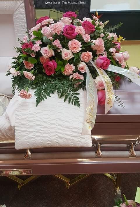 Time to remember - A beautiful casket spray with roses and carnations and various grains