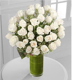 Clarity Luxury Rose Bouquet - The love you share is clear in your heart. The classic elegance and peaceful purity of our 24-inch premium long-stemmed white roses are delightfully elegant and sophisticated situated in a superior modern 10-inch clear glass cylindrical vase to create a dazzling display of limitless love and affection.  Includes: 48 stems of 24-inch premium long-stemmed white roses, exotic foliage and a superior 10-inch clear glass cylindrical vase. Approx. 26H x 23W Your purchase includes a complimentary personalized gift message.