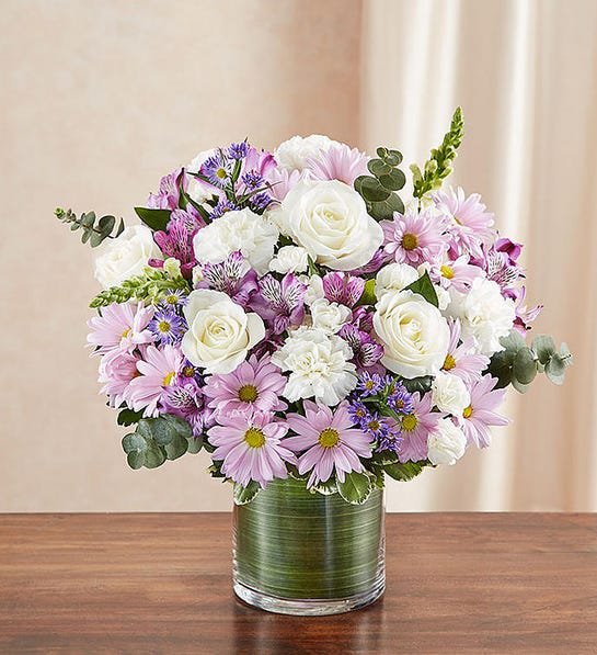 Cherished Memories - Lavender and White - Remember a loved one with elegance and grace by sending our peaceful lavender and white arrangement in a classic cylinder vase. The freshest roses, snapdragons, alstroemeria, carnations and more are gathered by our florists to offer a tribute to a beautiful life. 