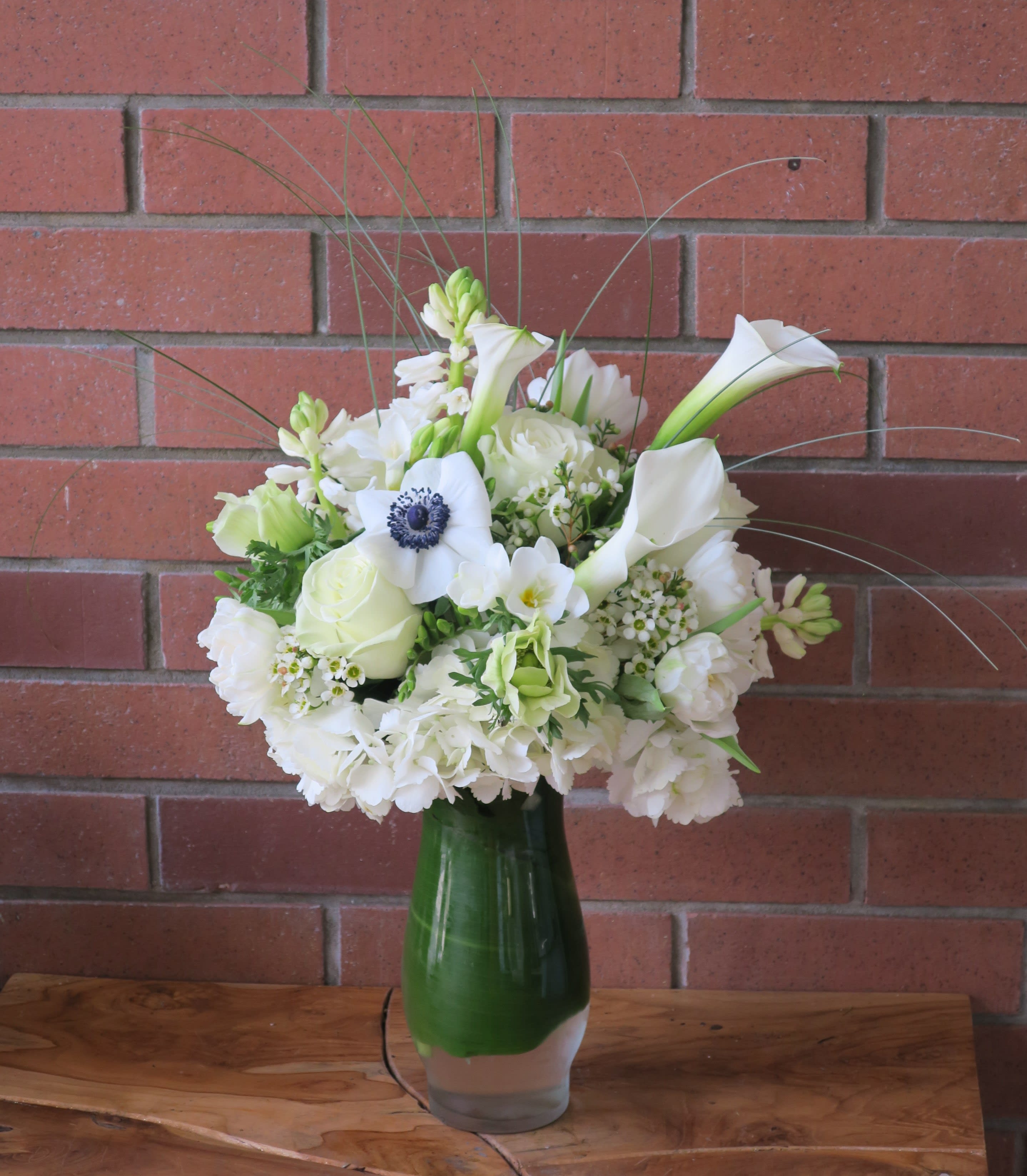 Prayer For Peace Bouquet Prayer For Peace Bouquet - White calla lilies, white hydrangeas, white roses, white anemones, tulips, freesia, wax flower lined with a beautiful tropical leaf, this arrangement is absolutely gorgeous