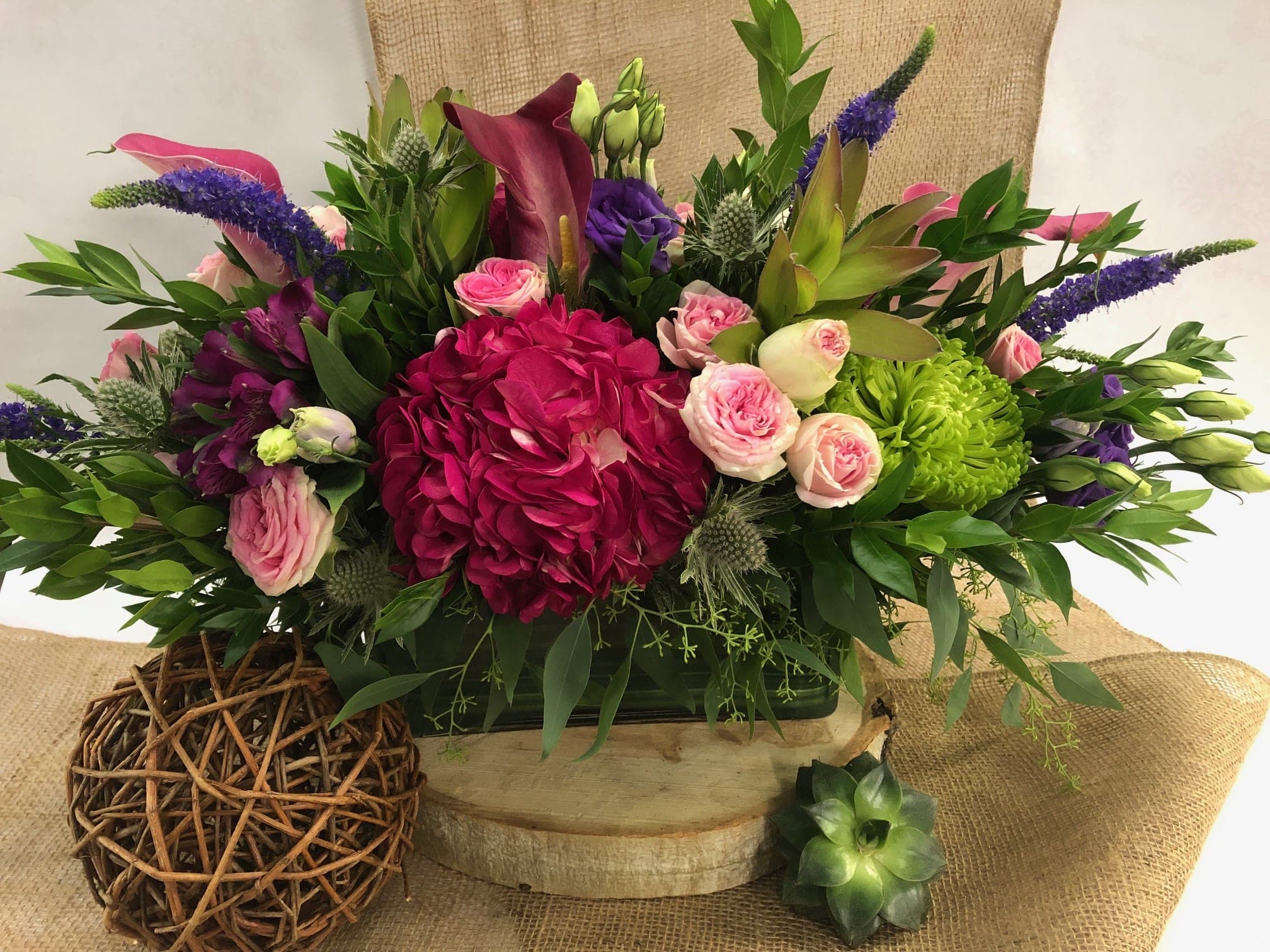 Beautiful Blooms  - This arrangement of flowers is absolutely breathtaking! Arranged in a rectangular modern vase it's sure to Wow anyone! A stunning assortment of mini callas, sweetheart roses, hydrangea, thistle and so much more. 