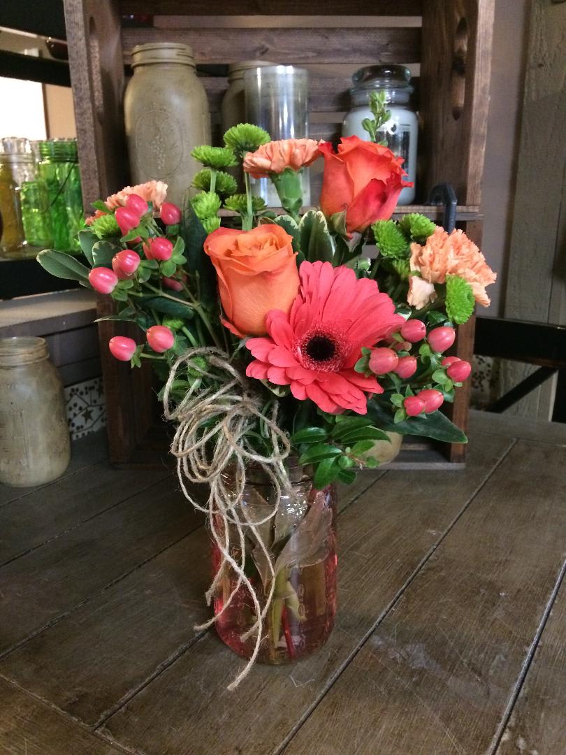 Country Garden - This garden gathered arrangement contains flowers in pinks, limes and oranges. 