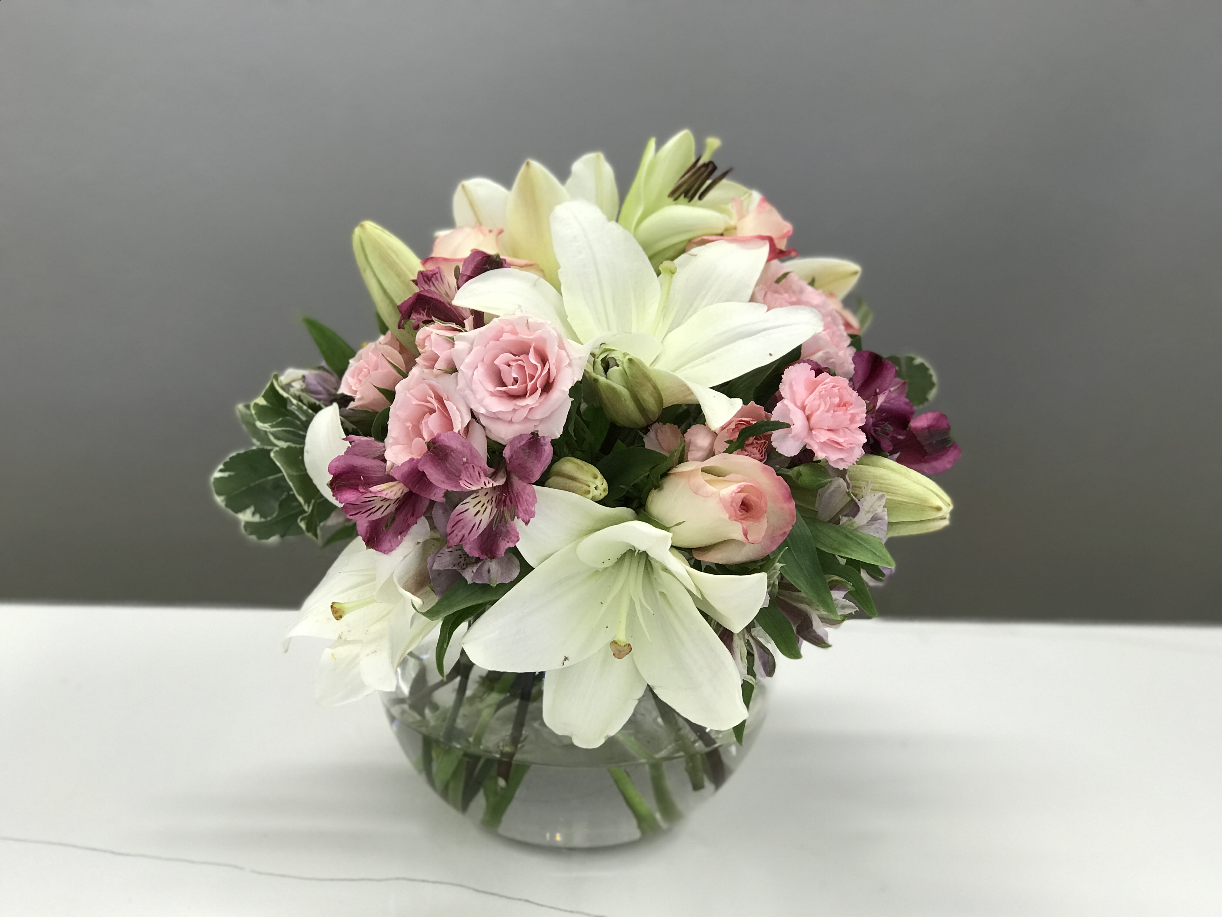 Blushing Bashful - Tones of blush and mauve touch upon white lilies for a playful elegance that says, &quot;you're special to me.&quot; 