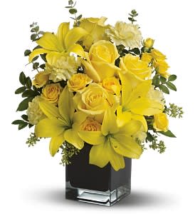 Teleflora's Ray of Sun Teleflora's Ray of Sun - Create a place in the sun for your favorite friend or family member with this sunny array of bright yellow flowers in a stunning contemporary black glass cube vase. They'll be your sunshine from now on.