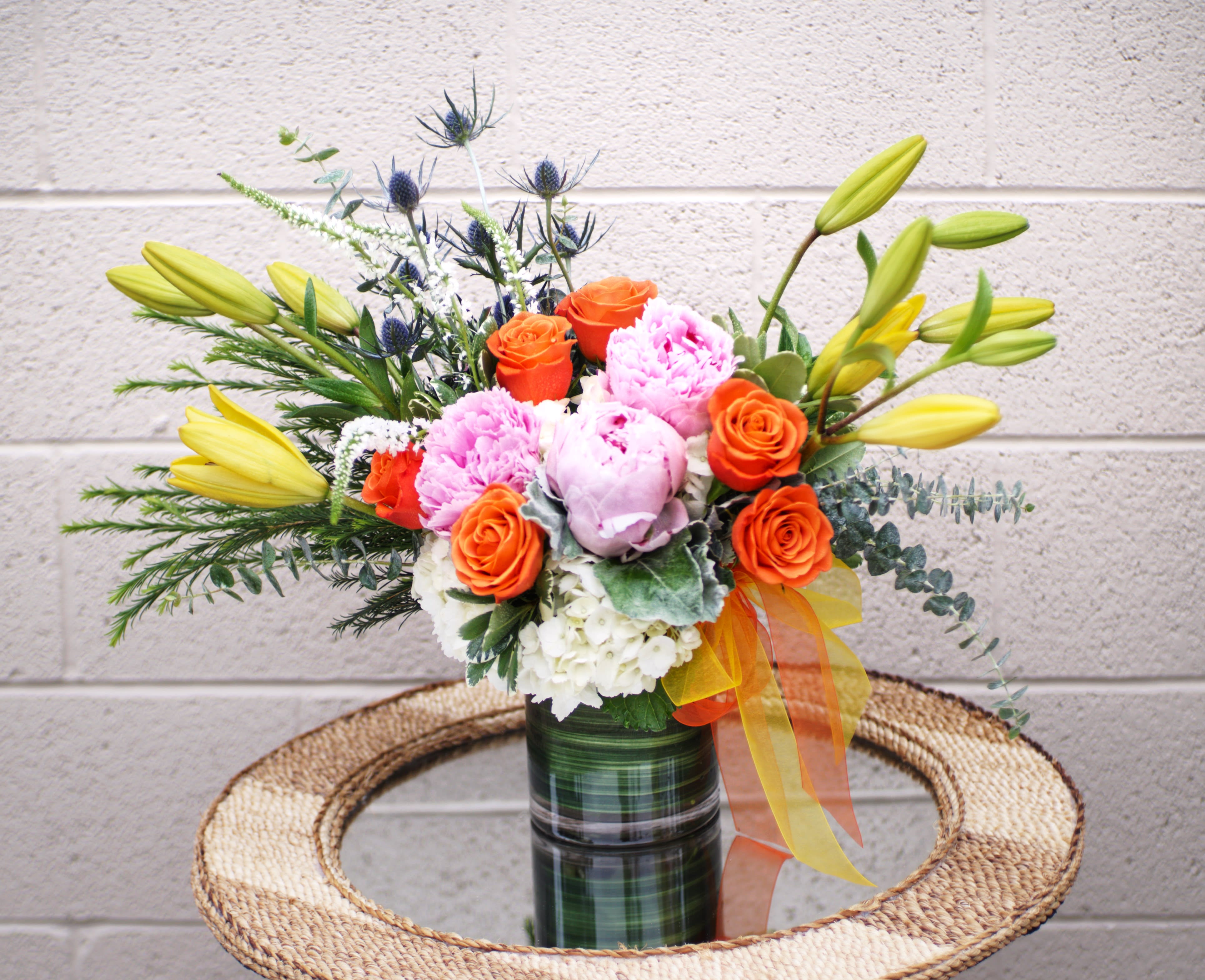New Dawn - Beautiful design including all premium seasonal flowers: rose, hydrangea, lily... and accents. STANDARD: FIRST PHOTO DELUXE: SECOND PHOTO