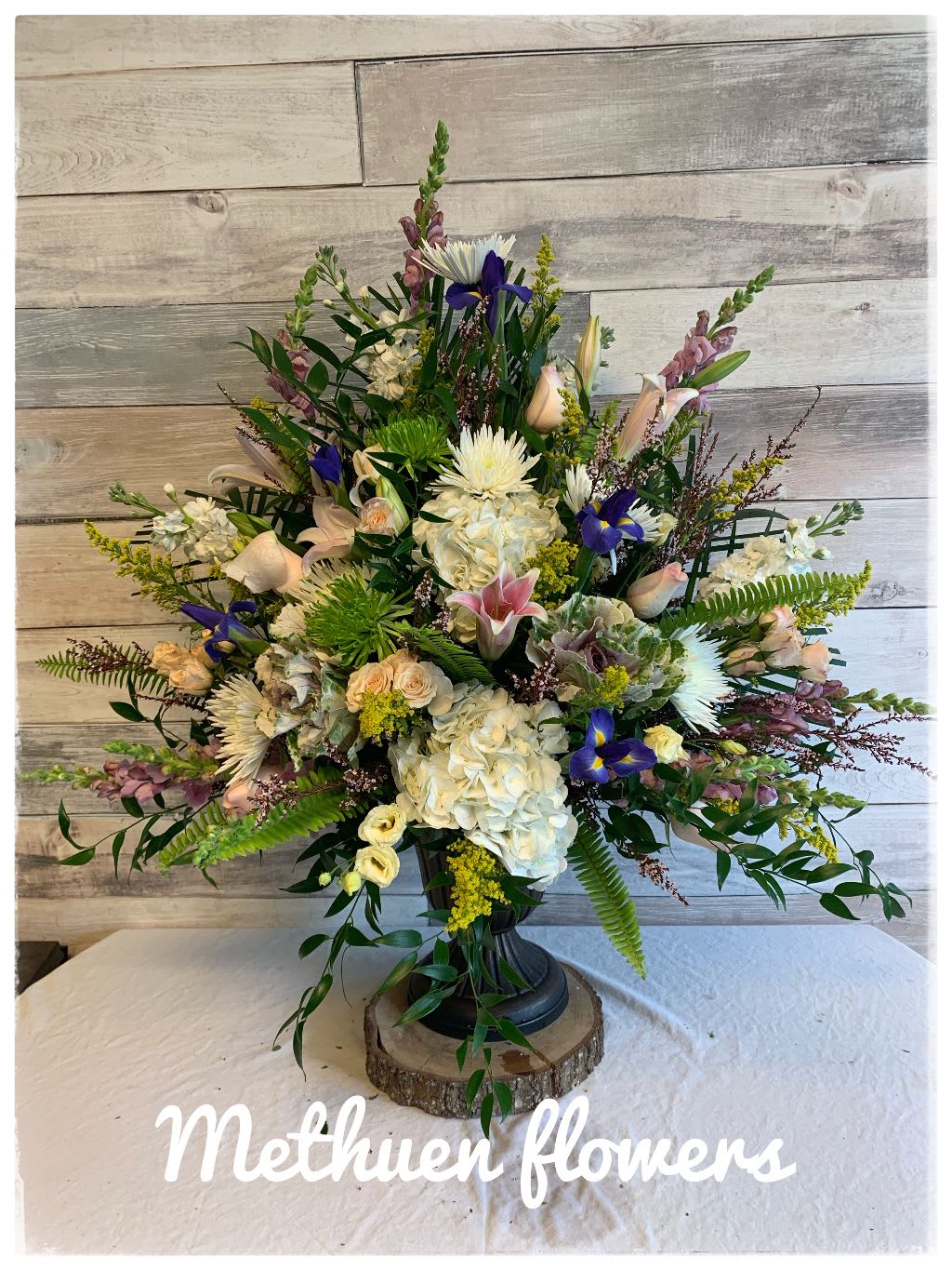 Funeral Pedestal Arrangement - Pedestal container with mixed seasonal flowers, such as hydrangeas, roses, snap dragons and much more.