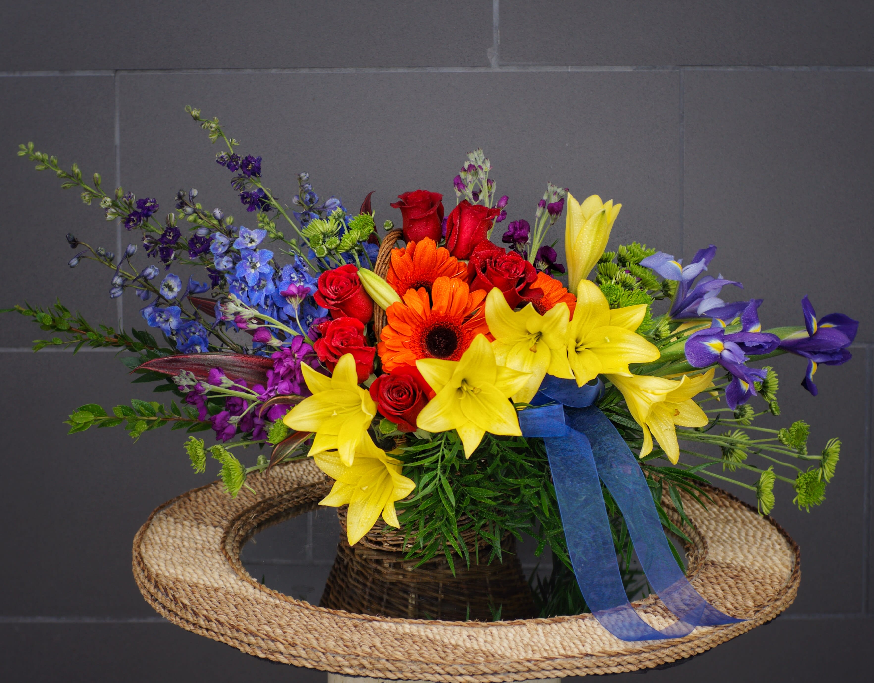 Rainbow Serenity - Rainbow blooms symbolize peace and serenity. This design includes rose, lily, gerbera, fragrant stock....
