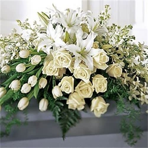 WHITE BEAUTY CASKET SPRAY WHITE BEAUTY CASKET SPRAY - White casket spray designed with french tulips, equatorien roses, dendrobium orchids, casablanca lilies...