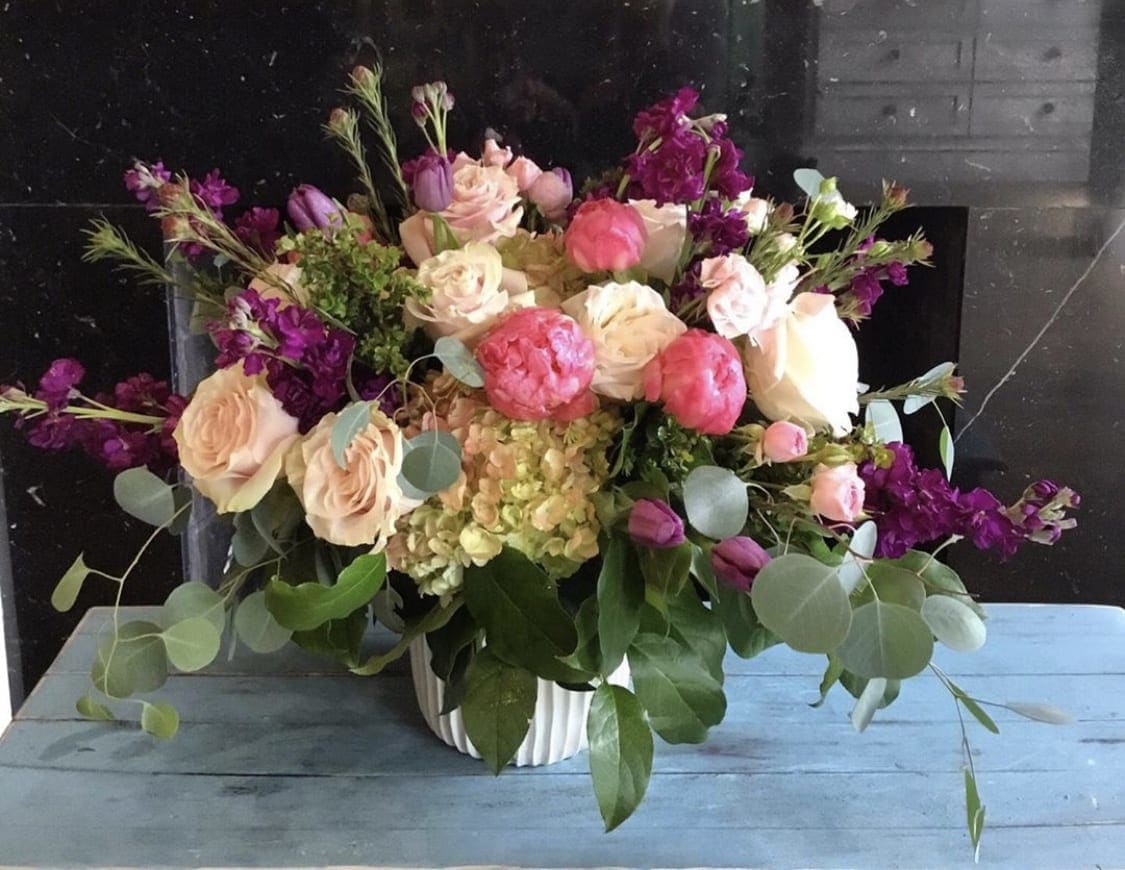 Peachy Keen - Beautiful array of florals in our signature white vase. Tulips, Hydrangea, Peonies, Stock, Lisianthus, Spray roses.