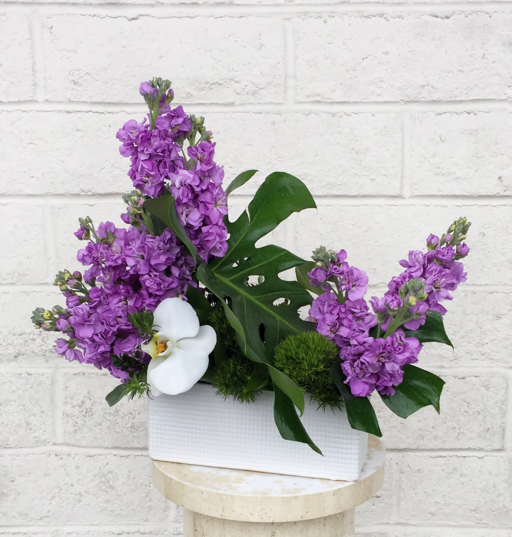 Peaceful Mind - A Zen design including fragrant stock and orchid with accents in a nice container.