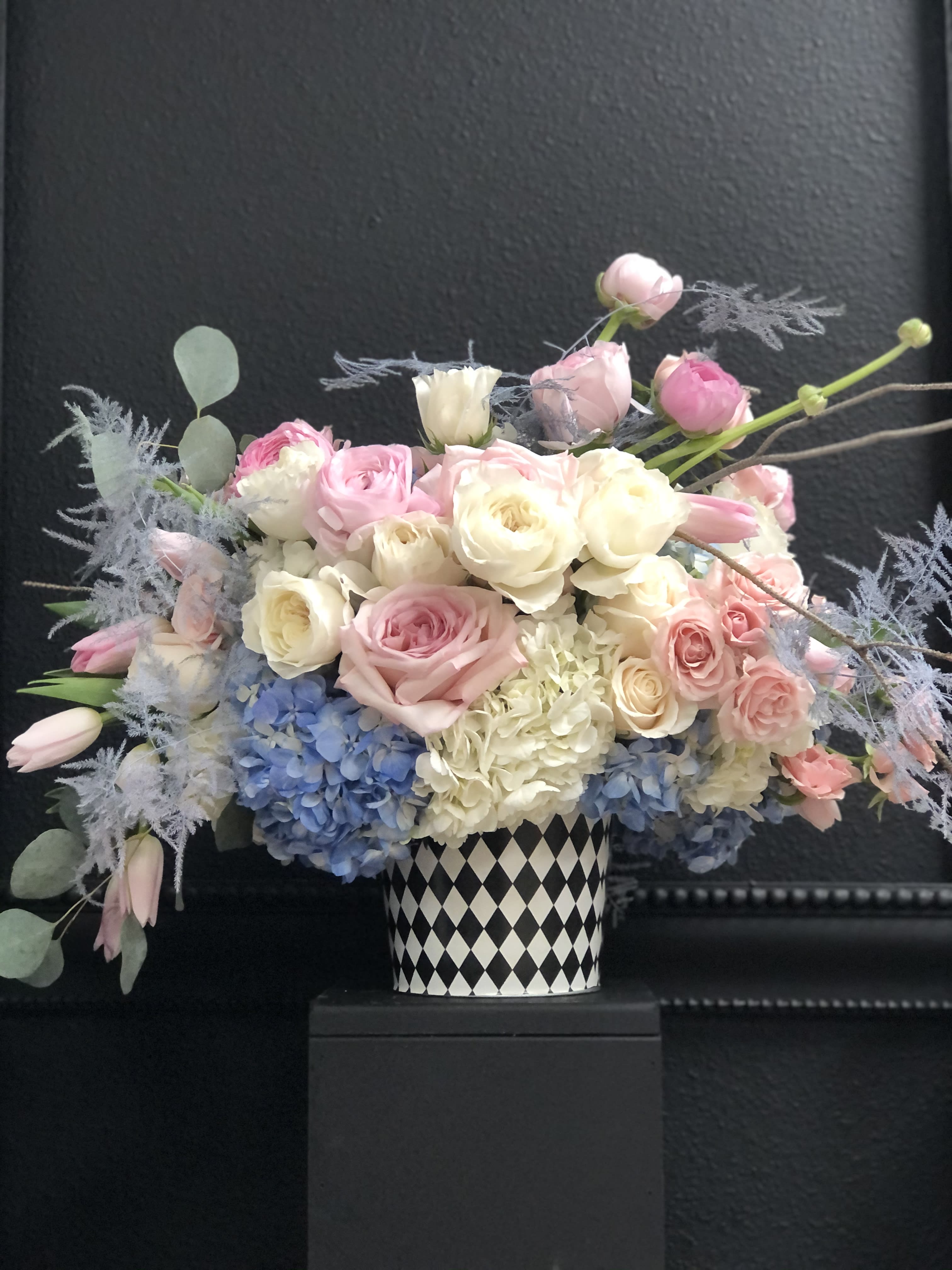 France - Pink and blue flowers mixed with white in whimsical  black and white  container. Delightful arrangement for newborn babies, gender reveal or just because.