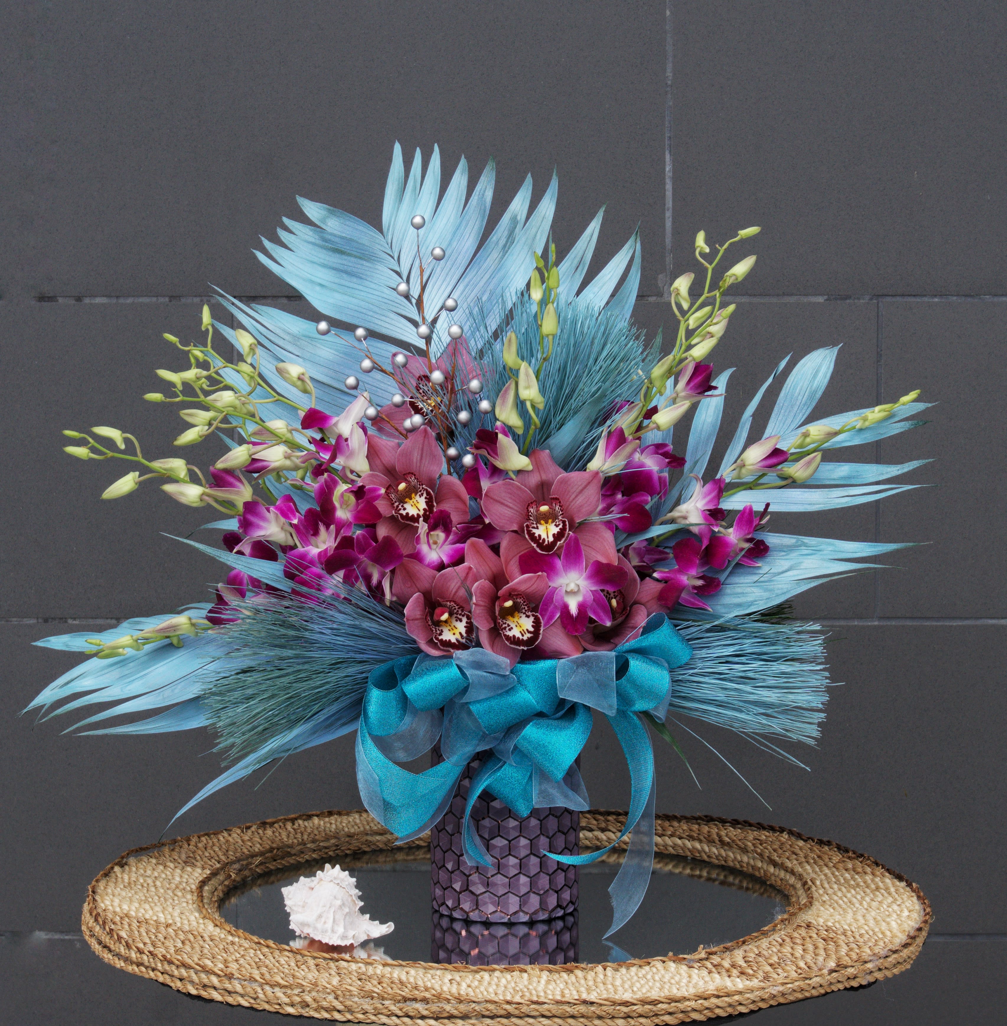 Waving Palms - Ocean Breeze design including orchids and palm leaves in a nice vase.