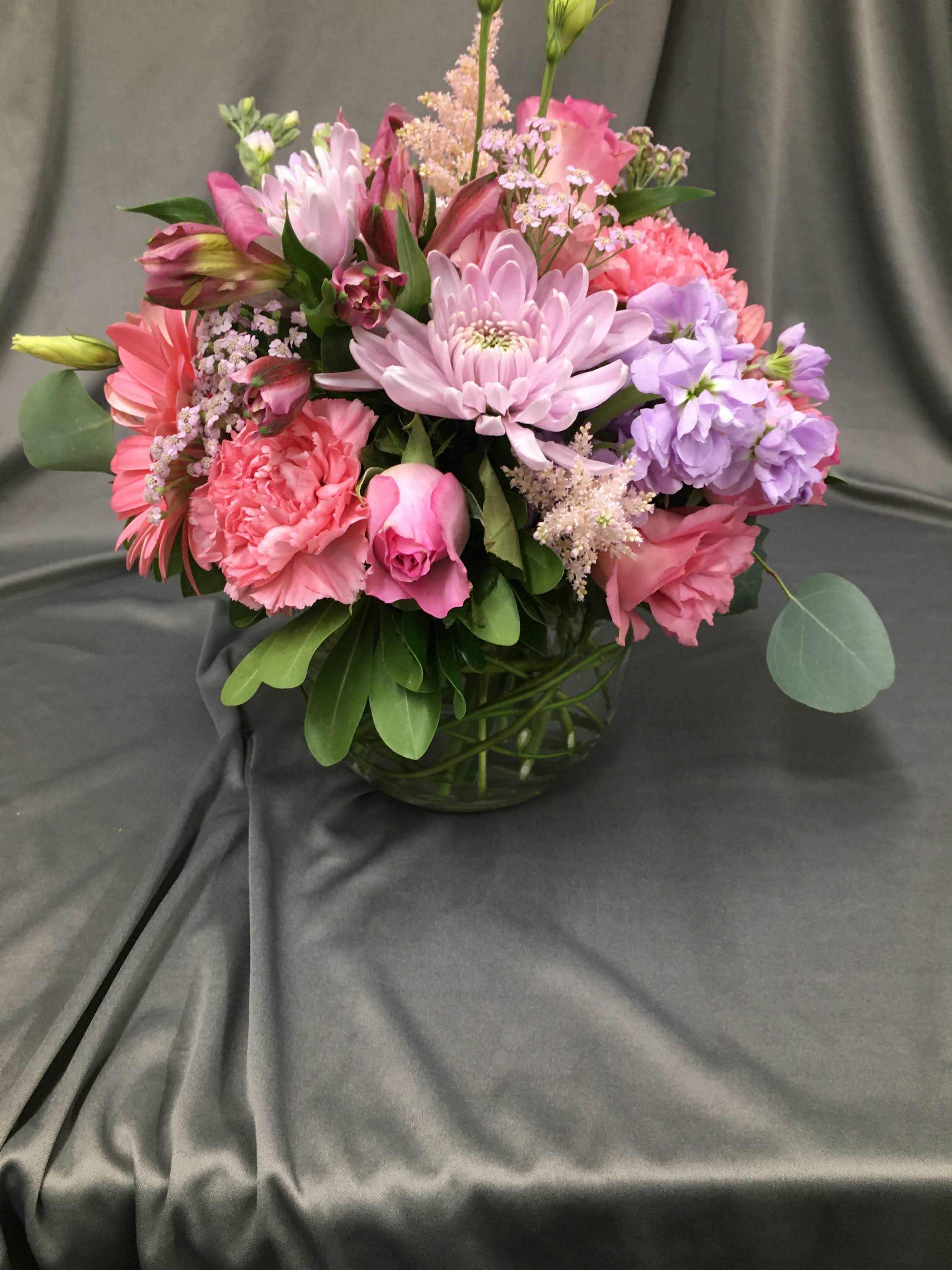 Pink Perfection Pink Perfection - This soft display of pink carnations, alstromeria, and purple roses with a touch of white stock is a delicate way to send flowers for an illness, thank you, baby girl congratulations or just because. **pictured at $75.00**